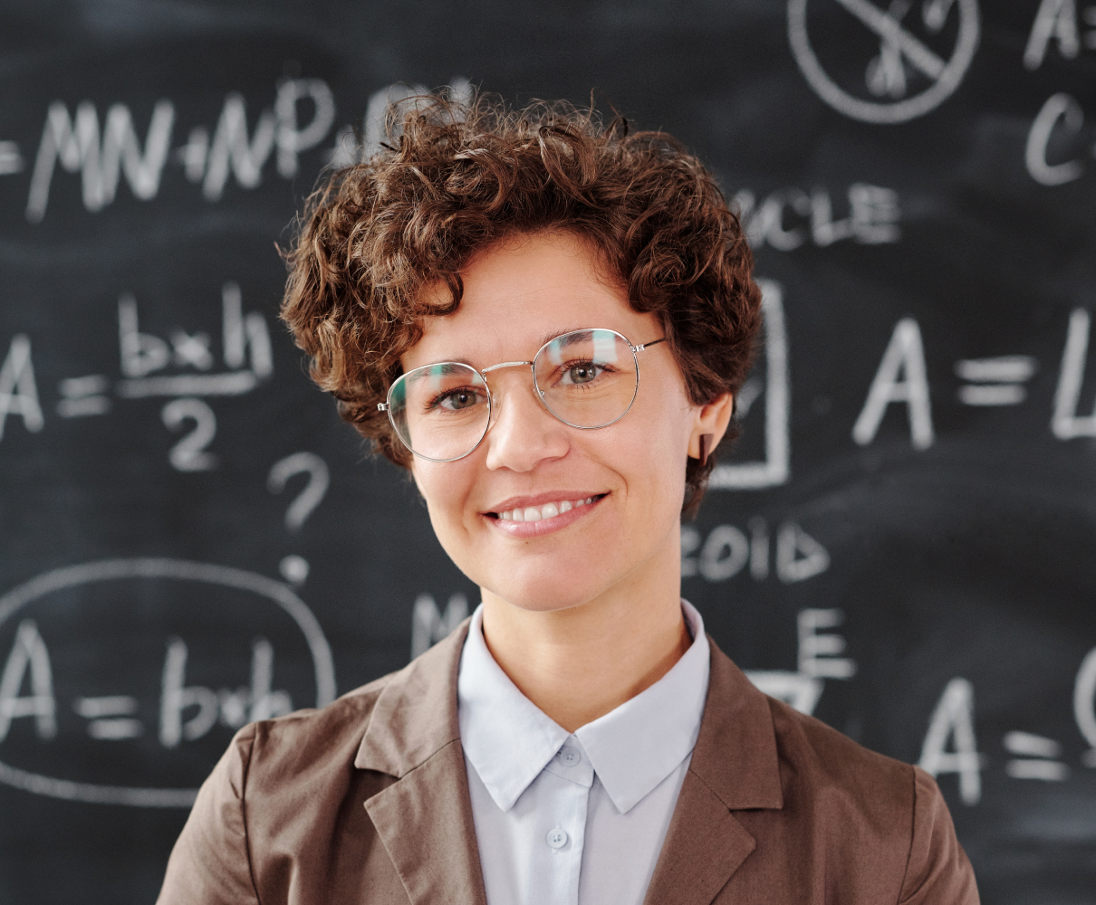 A smiling educator in a classroom.